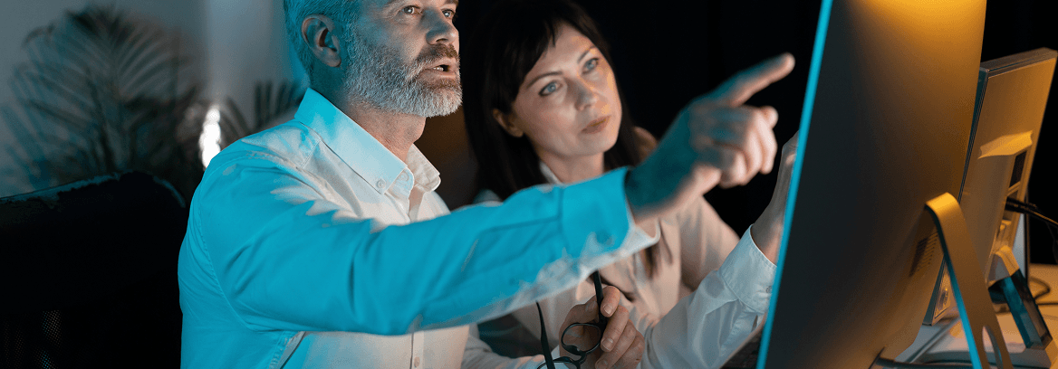 A man and woman look intently at a computer screen under the banner “Compensation shouldn’t be stressful,” promoting a compensation analysis offer.