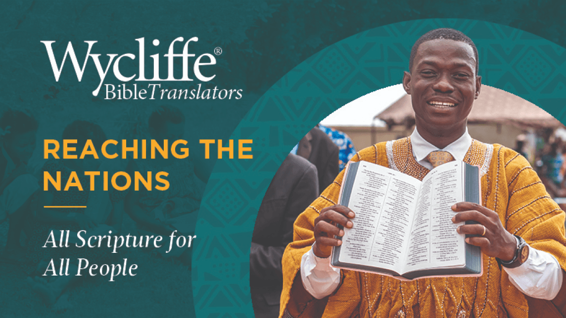 Smiling man holding a translated Bible, representing Wycliffe’s global mission to share scripture with all people.