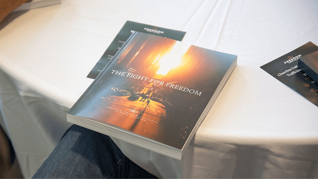 Book titled "The Fight for Freedom" sits on a table with a glowing city scene on the cover.