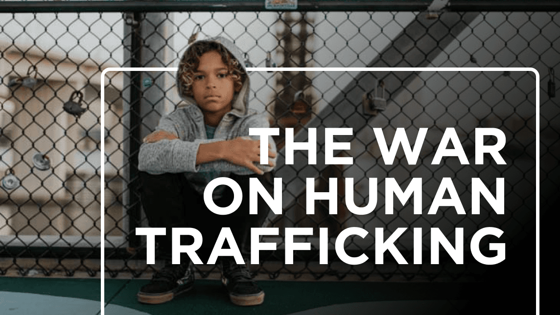 Child sitting alone behind a chain-link fence with the overlaid text “THE WAR ON HUMAN TRAFFICKING.”