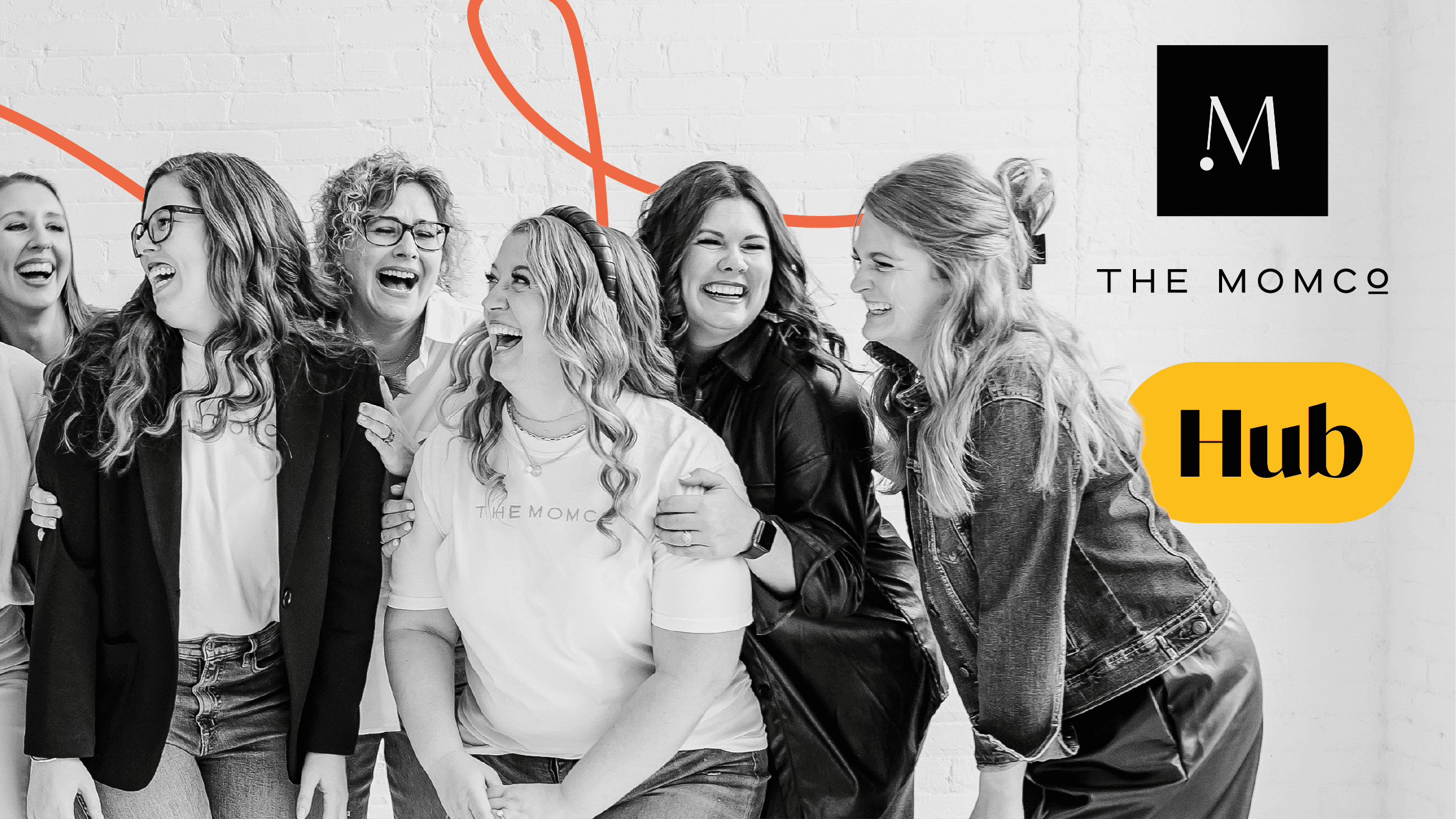 Group of smiling women standing together with The MomCo logo and ‘Hub’ label on a black and yellow background.
