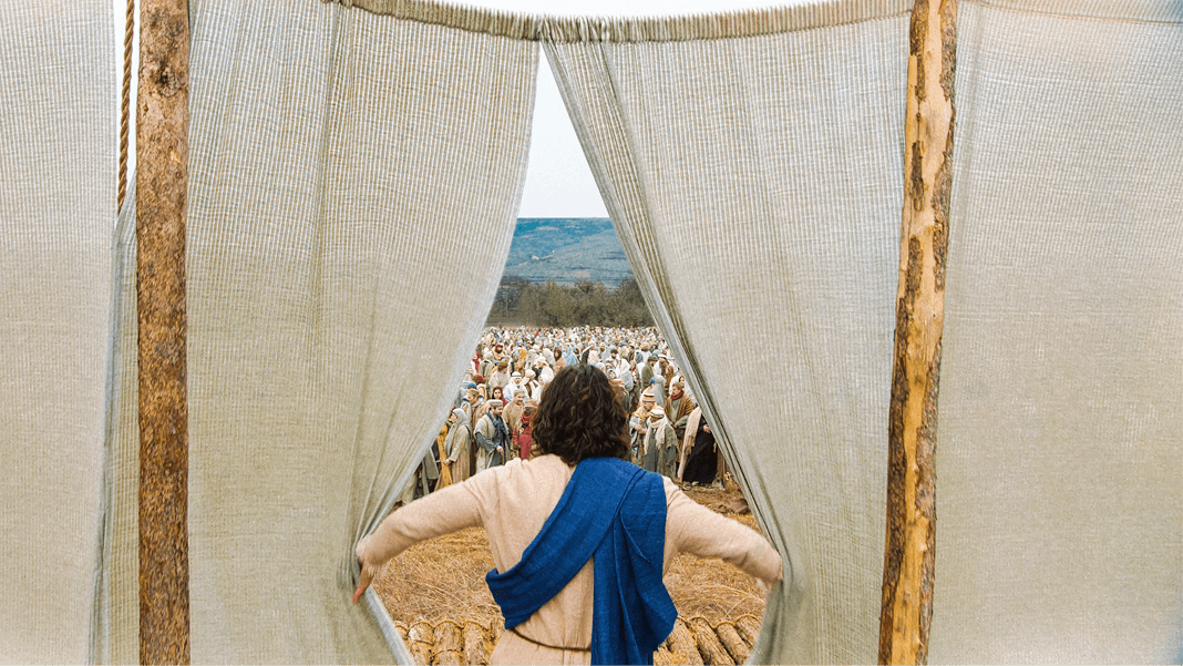 View from behind Jesus as he parts curtains and sees a large crowd in the distance.